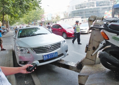 交警將違法停放在緯五路一所學(xué)校門(mén)口的車輛拖走
