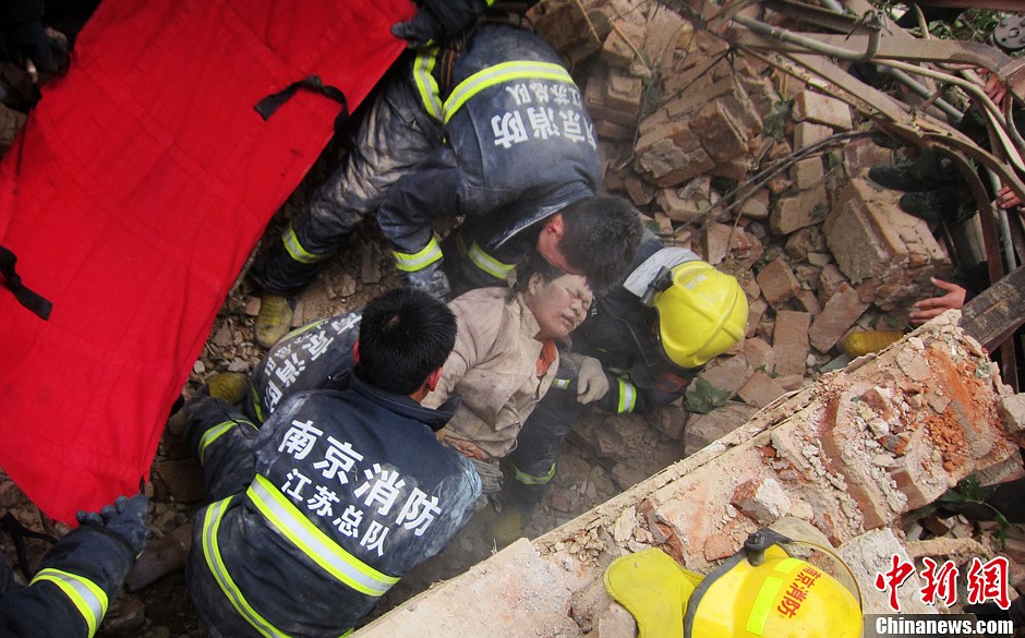 圖為南京消防隊員從廢墟中將傷者抬出。中新社發(fā) 梅亮 攝