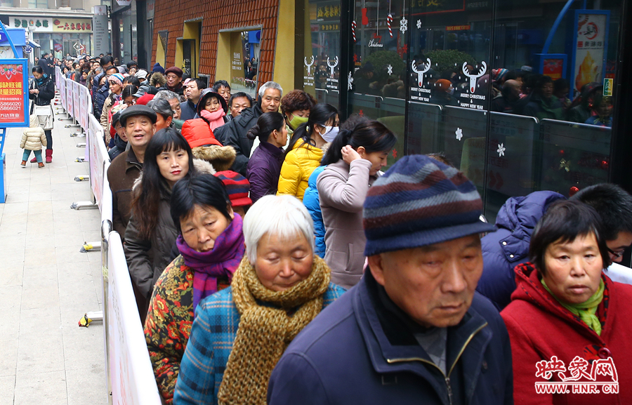 領(lǐng)粥的市民排起了長隊(duì)，足有上千人。
