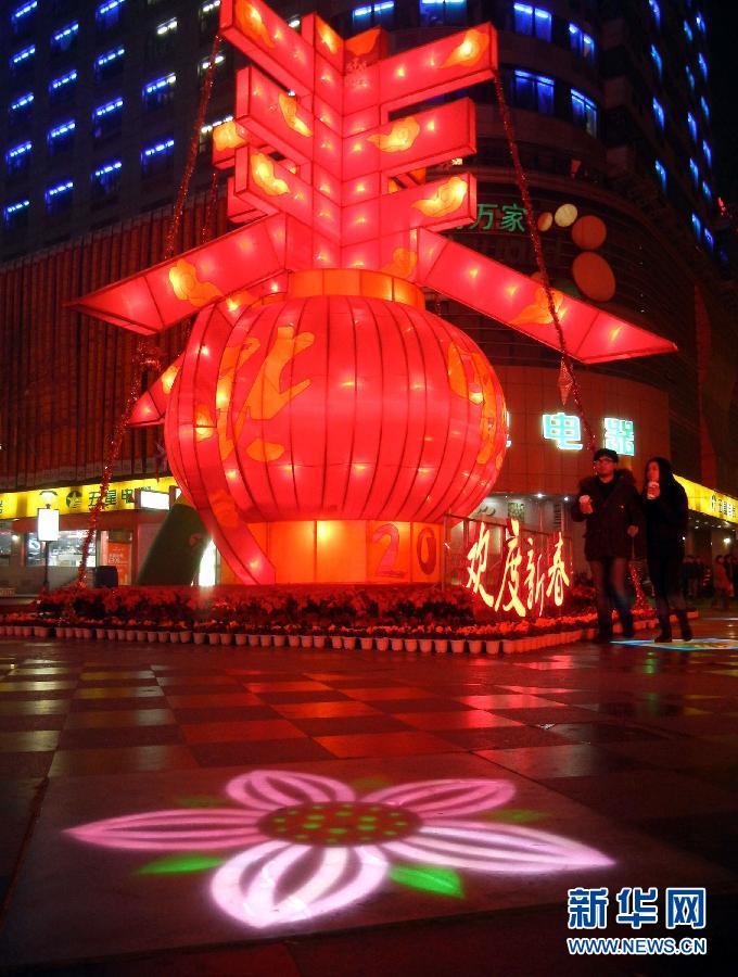 　1月30日晚，市民從蘇州市石路銀河廣場(chǎng)上大型“春”字彩燈景觀旁經(jīng)過(guò)。