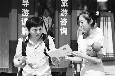 9月13日，西安臨潼華清池景區(qū)服務(wù)人員向游客介紹《旅游法》。