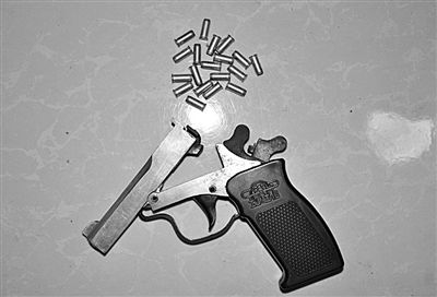 警方從搶劫嫌疑人處起獲的贓款和發(fā)令槍、子彈。警方供圖