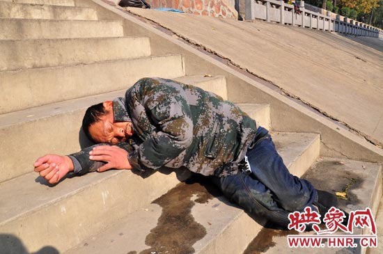 這名男子的衣服以及褲子全濕透了，水從衣褲里流出來，嘴里散發(fā)著濃烈的酒氣。