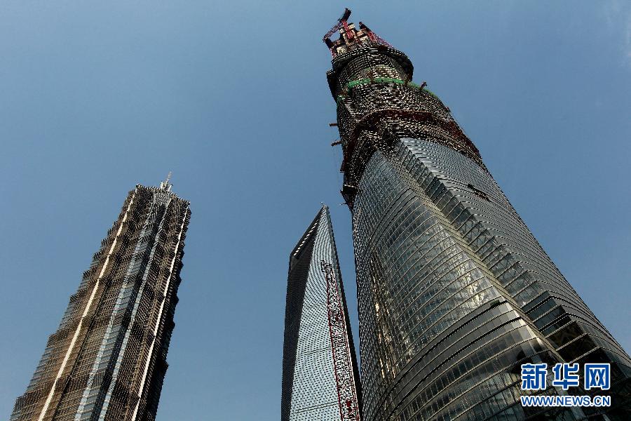 4月11日，正在建設(shè)中的“上海中心”（右）的高度已超過金茂大廈（左）和上海環(huán)球金融中心（中）。