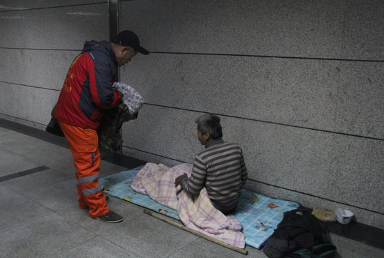 在鄭州一處地下通道，孫德坤挑了幾件衣服送給了流浪者