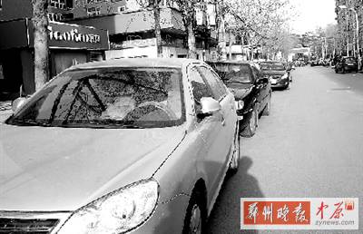 友愛(ài)路，路邊停了一排車，本來(lái)不寬的路就變得更窄了。