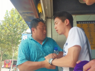 記者正查看照片，突遭藍(lán)衣男強(qiáng)搶手機(jī)。