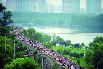 　　昨天,數(shù)萬南京市民參加“環(huán)城七十里”徒步走,圖為解放門城墻上密集的人群。 本版攝影 實(shí)習(xí)生 王甜